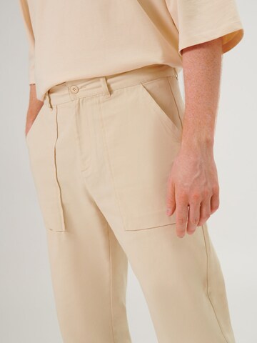 ABOUT YOU x Swalina&Linus Regular Trousers 'Leo' in Beige