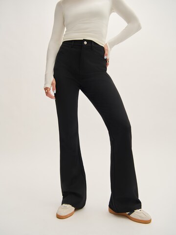 Tatiana Zidekova Flared Trousers in Black: front