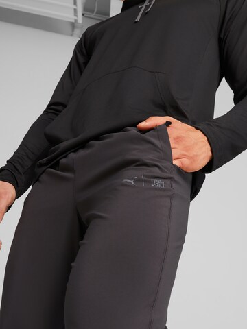 PUMA - Tapered Pantalón deportivo en negro