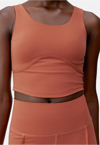 Born Living Yoga Sports top 'Sayani' in Orange