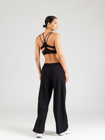 UNDER ARMOUR - Pierna ancha Pantalón deportivo 'Motion' en negro