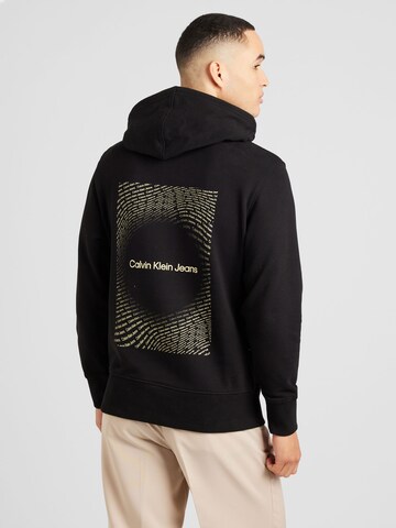 Sweat-shirt Calvin Klein Jeans en noir : devant