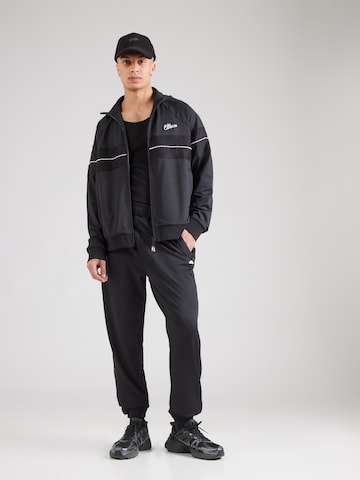 ELLESSE - Tapered Calças em preto