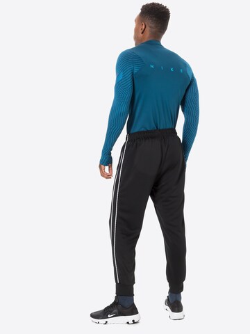 Nike Sportswear Zwężany krój Spodnie 'Repeat' w kolorze czarny