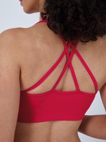 SPORTKIND Medium support Sport bh 'Crossed Straps' in Roze