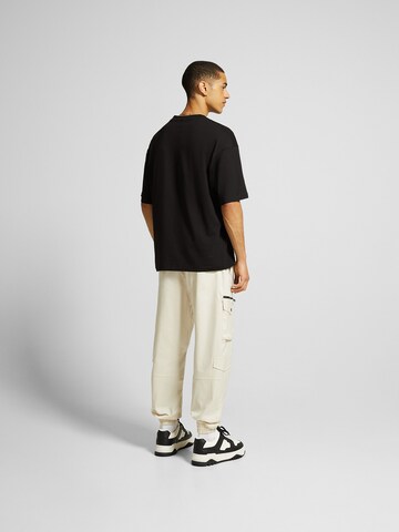 Bershka Tapered Cargo nadrágok - sárga