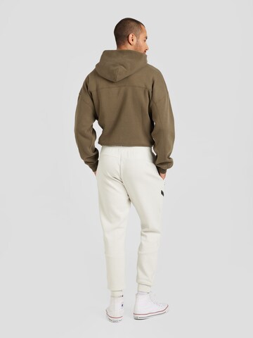 UNDER ARMOUR Tapered Sportsbukser 'Unstoppable' i hvid