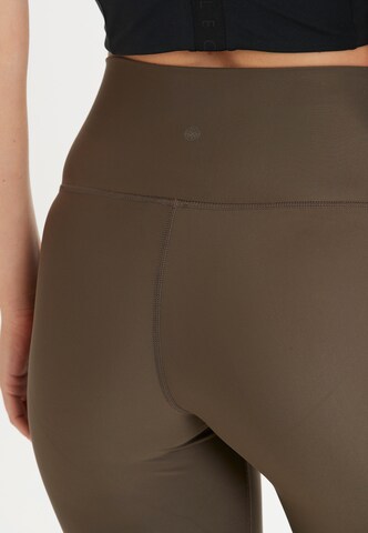 Athlecia Skinny Sportbroek 'Cadidell' in Bruin