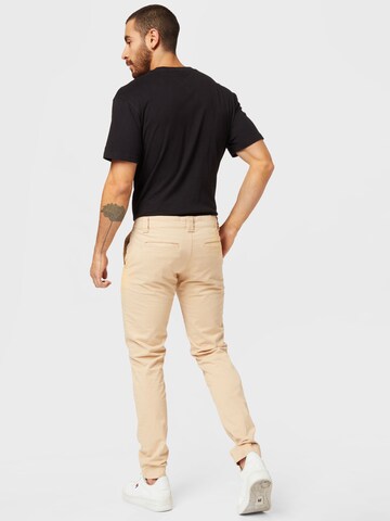 Tommy Jeans Slimfit Chinohousut 'SCANTON' värissä beige