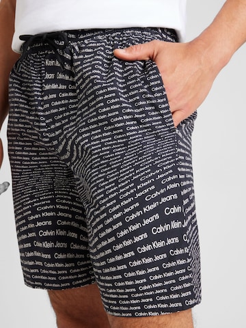 Calvin Klein Jeans Regular Trousers 'AOP' in Black