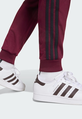 Tapered Pantaloni 'SST' di ADIDAS ORIGINALS in rosso