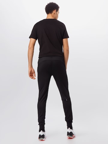 PUMA Tapered Sportbroek in Zwart