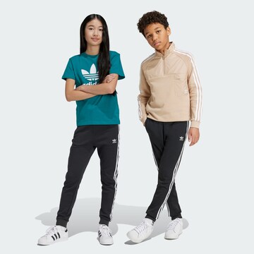 Tapered Pantaloni 'Trefoil' di ADIDAS ORIGINALS in nero: frontale