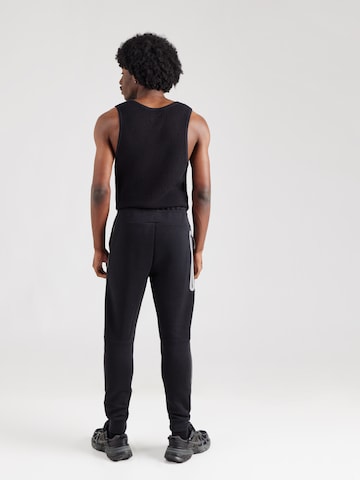 Effilé Pantalon 'TECH FLC' Nike Sportswear en noir