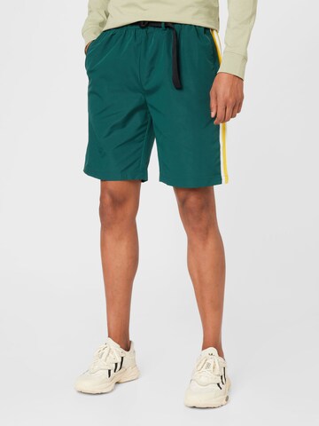 Mennace Regular Trousers in Green: front