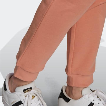 ADIDAS ORIGINALS Tapered Trousers in Orange