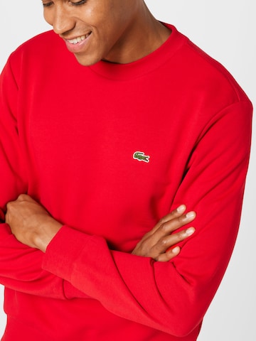 LACOSTE Sweatshirt i röd
