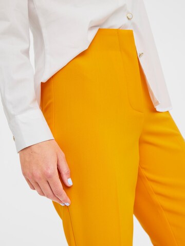 VERO MODA Regular Trousers with creases 'Sandy' in Orange