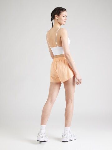 Athlecia - Loosefit Pantalón deportivo 'Arilay' en naranja