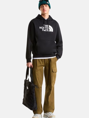 THE NORTH FACE Bluzka sportowa 'THE NORTH FACE M ESS DP REG HODDIE FELPA' w kolorze czarny