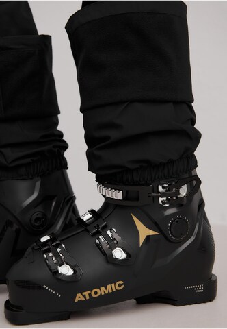 évasé Pantalon de sport Aim'n en noir