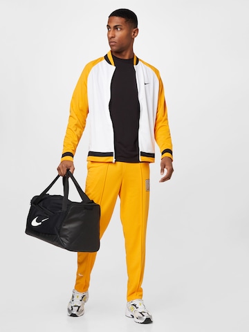 NIKE Tapered Workout Pants in Yellow