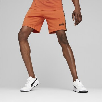 PUMA Regular Workout Pants in Orange