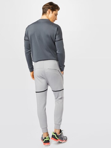 Effilé Pantalon de sport OAKLEY en gris