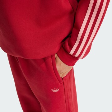 ADIDAS ORIGINALS Tapered Trousers in Red