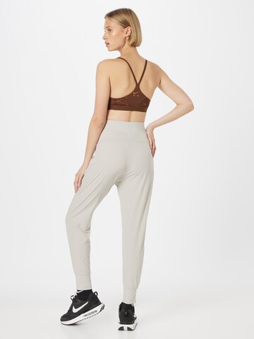 NIKE Tapered Sportsbukser 'Bliss Luxe' i grå