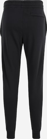 UNDER ARMOUR Tapered Sports trousers in Black