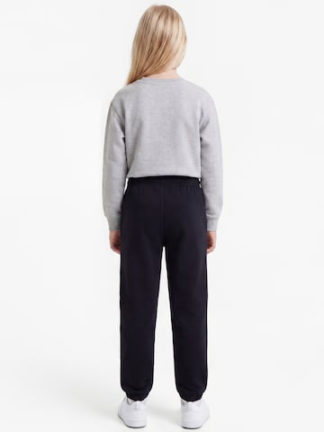 Nike Sportswear Tapered Παντελόνι 'STUDIO' σε μαύρο