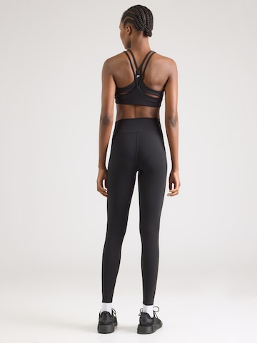 UNDER ARMOUR Skinny Sportnadrágok 'Motion' - fekete