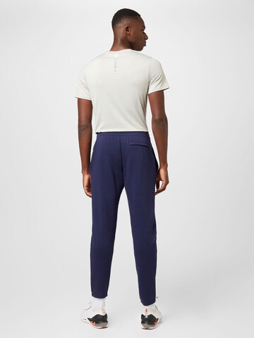 UNDER ARMOUR Дънки Tapered Leg Спортен панталон 'Essential' в синьо