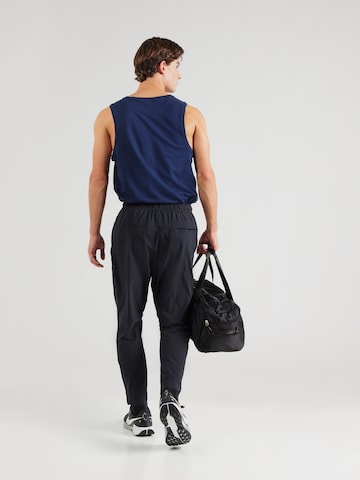 Effilé Pantalon de sport 'Unlimited' NIKE en noir
