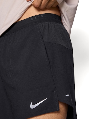 NIKE Szabványos Sportnadrágok 'STRIDE' - fekete