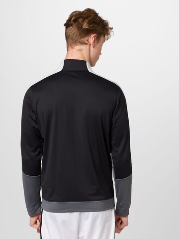 Veste de survêtement UNDER ARMOUR en noir