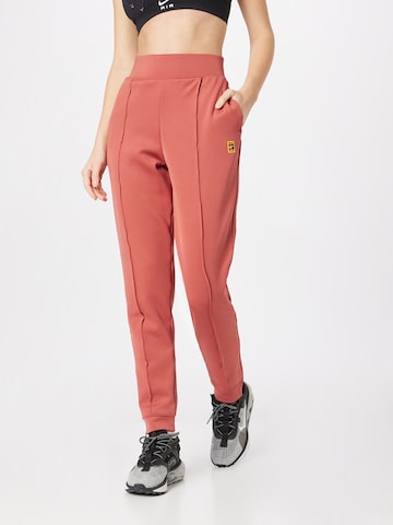 NIKE Tapered Workout Pants in Red: front