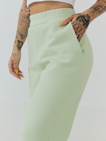 ABOUT YOU x Sharlota Tapered Trousers 'Nala' in Green
