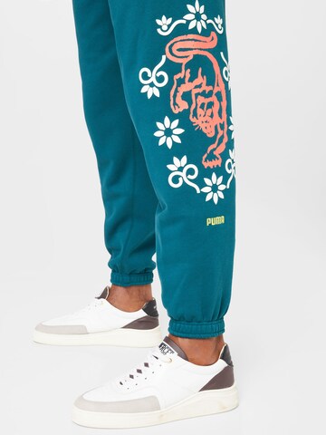 PUMA Tapered Sports trousers 'Run it Back' in Green