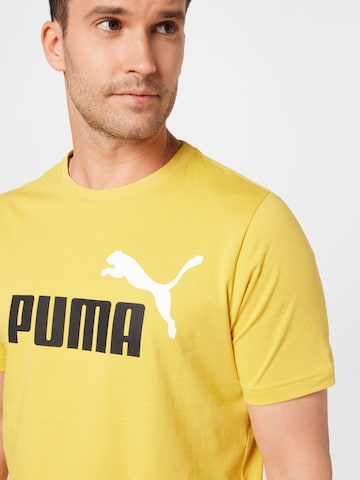 PUMA Λειτουργικό μπλουζάκι 'Essentials' σε κίτρινο