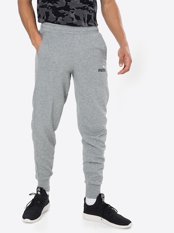 PUMA - Tapered Calças de desporto em cinzento: frente