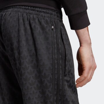 ADIDAS ORIGINALS Loose fit Trousers 'Graphics Monogram' in Black