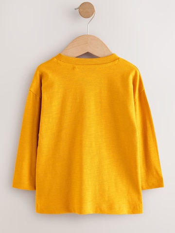 Tricou de la Next pe bej