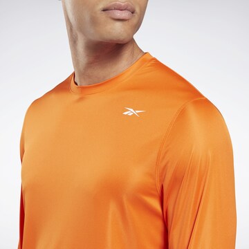 Reebok - Camisa funcionais em laranja