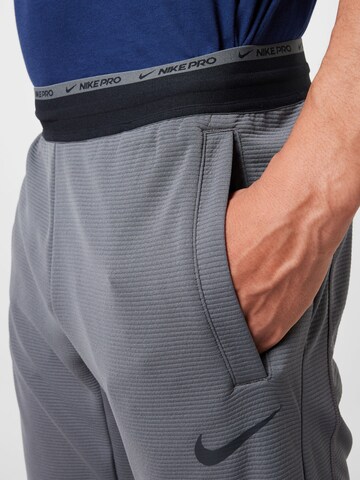 NIKE Regular Workout Pants in Grey