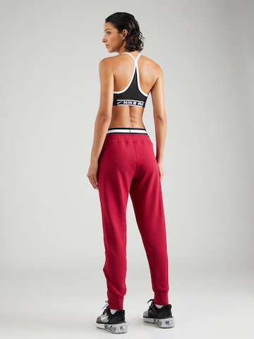 NIKE Tapered Sports trousers in Red