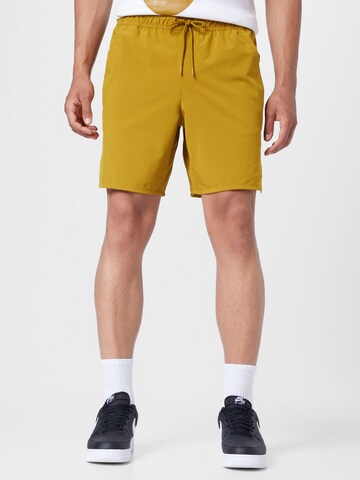 NIKE Regular Workout Pants 'Unlimited' in Yellow: front