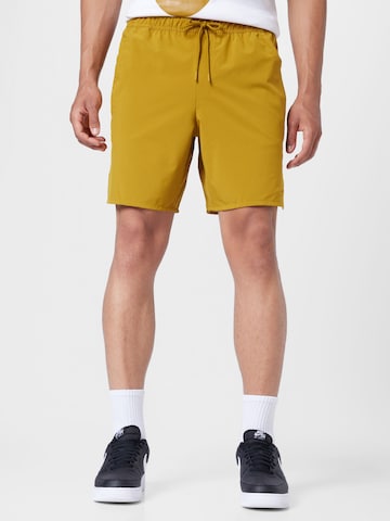Regular Pantalon de sport 'Unlimited' NIKE en jaune : devant
