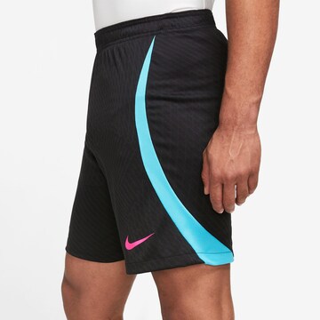 NIKE Loose fit Sports trousers 'Strike' in Black